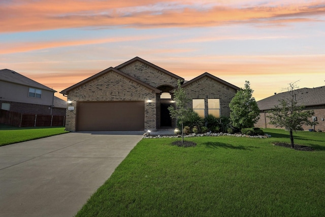 632 Dunster Ln, Saginaw, TX 76131 - french provincial home featuring brick siding, concrete driveway, an attached garage, and a yard