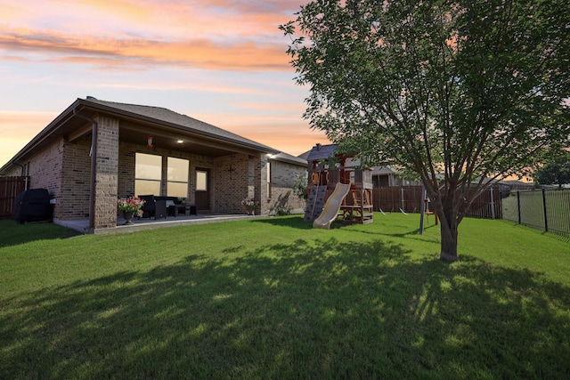 632 Dunster Ln, Saginaw, TX 76131 - rear view of property featuring a playground, brick siding, and a patio