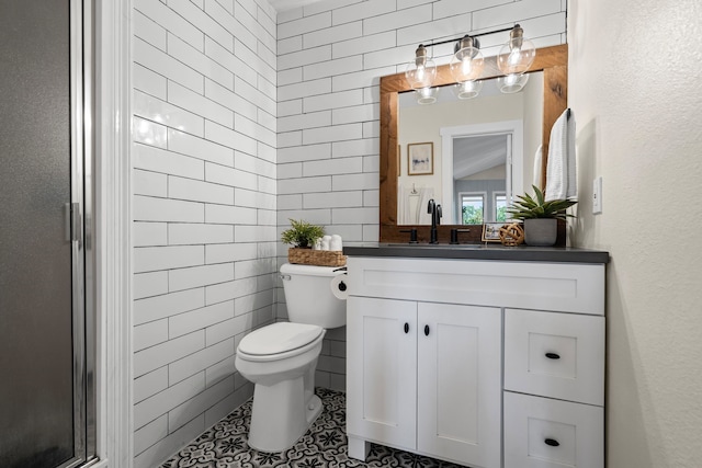 1418 Lakeshore Blvd, Oak Point, TX 75068 - bathroom featuring toilet, vanity, tile walls, tile patterned flooring, and a stall shower