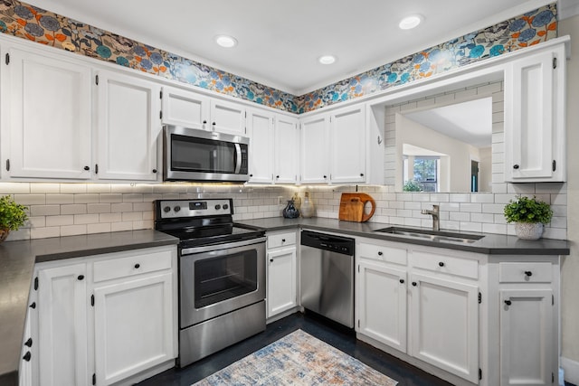 1418 Lakeshore Blvd, Oak Point, TX 75068 - kitchen with appliances with stainless steel finishes, dark countertops, white cabinets, and recessed lighting