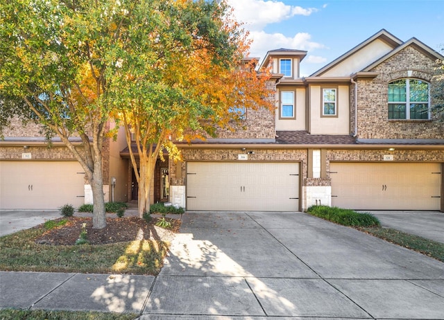 316 Tallgrass Ln, Plano, TX 75023 - townhome / multi-family property with a garage, stucco siding, concrete driveway, and stone siding