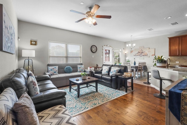 316 Tallgrass Ln, Plano, TX 75023 - living area with a chandelier, a ceiling fan, and dark wood-style floors