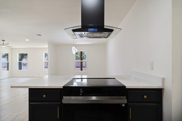 6625 Bridges Ave, Richland Hills, TX 76118 - kitchen featuring wall chimney range hood, range with electric cooktop, dark cabinets, and open floor plan
