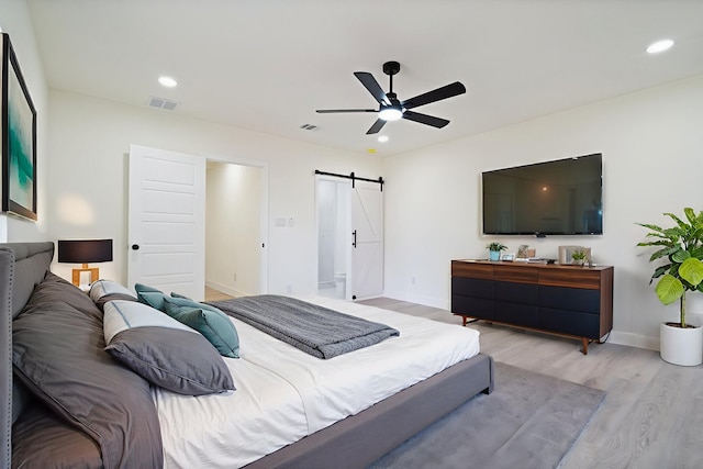 6625 Bridges Ave, Richland Hills, TX 76118 - bedroom featuring a barn door, wood finished floors, baseboards, recessed lighting, and ceiling fan