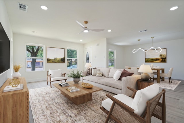 6625 Bridges Ave, Richland Hills, TX 76118 - living area featuring wood finished floors, plenty of natural light, recessed lighting, ceiling fan, and baseboards
