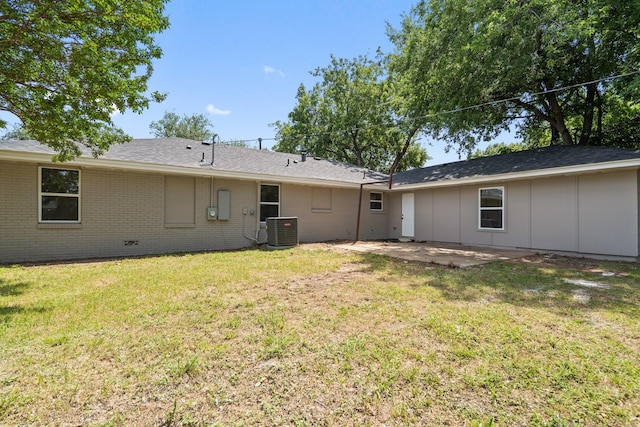 6625 Bridges Ave, Richland Hills, TX 76118 - rear view of house featuring central AC, a patio, brick siding, and a yard
