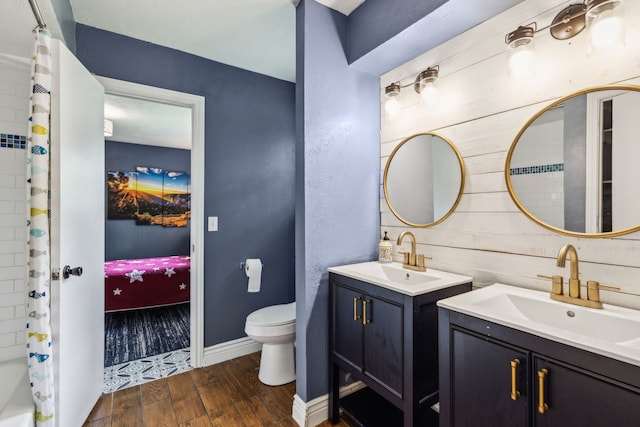 5906 Gregory Ln, Parker, TX 75002 - bathroom with two vanities, wood finished floors, toilet, and curtained shower