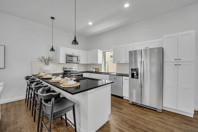 5806 Bryan Pkwy Unit 4, Dallas, TX 75206 - kitchen featuring appliances with stainless steel finishes, a sink, dark countertops, white cabinets, and recessed lighting