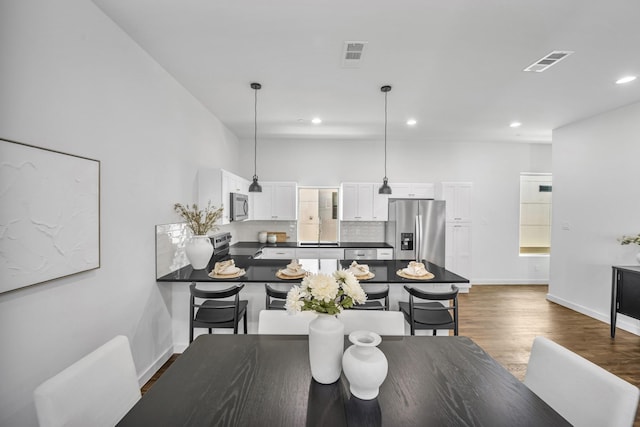 5806 Bryan Pkwy Unit 4, Dallas, TX 75206 - dining room with dark wood-style flooring, recessed lighting, and baseboards