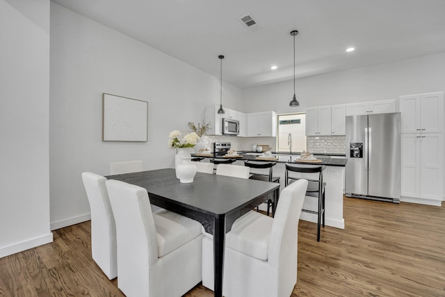 5806 Bryan Pkwy Unit 4, Dallas, TX 75206 - dining area with light wood-style flooring, recessed lighting, and baseboards