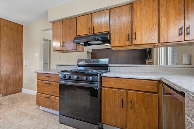 1413 Rockbrook St, Lancaster, TX 75134 - kitchen with stainless steel range with gas cooktop, under cabinet range hood, light countertops, brown cabinetry, and light tile patterned floors