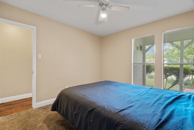 1413 Rockbrook St, Lancaster, TX 75134 - carpeted bedroom with baseboards, ceiling fan, and wood finished floors