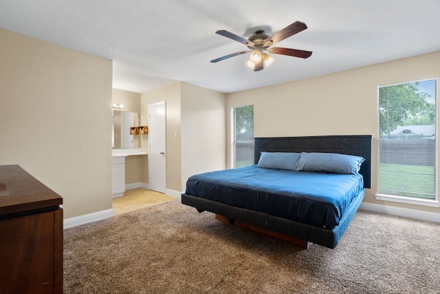 1413 Rockbrook St, Lancaster, TX 75134 - carpeted bedroom featuring multiple windows, ceiling fan, baseboards, and ensuite bath