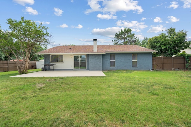 1413 Rockbrook St, Lancaster, TX 75134 - rear view of property with a patio, a chimney, and brick siding