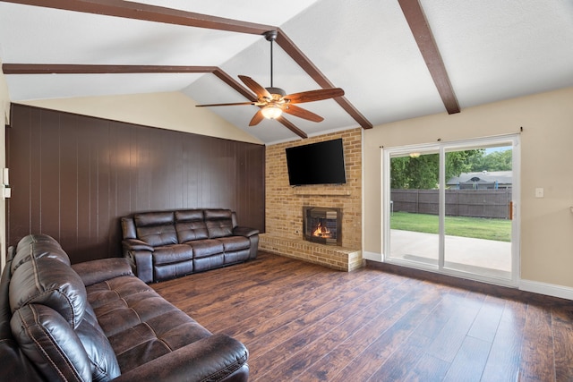 1413 Rockbrook St, Lancaster, TX 75134 - living room featuring dark wood finished floors, ceiling fan, a fireplace, wooden walls, and baseboards
