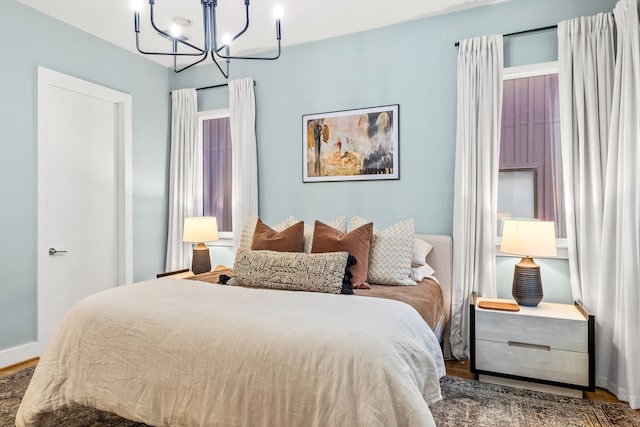 1928 Kearney Ct, Dallas, TX 75204 - bedroom with wood finished floors, a chandelier, and baseboards