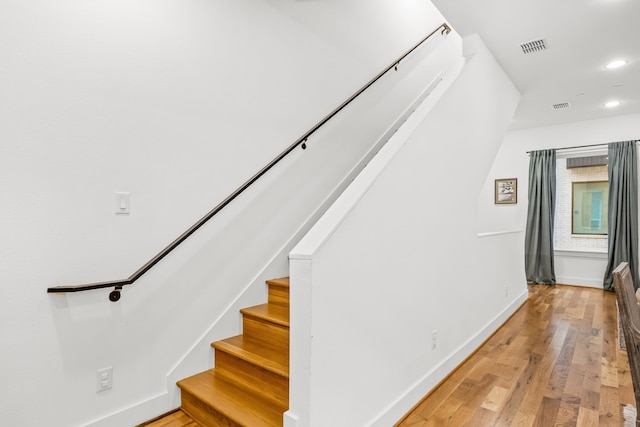 1928 Kearney Ct, Dallas, TX 75204 - stairway with wood finished floors, baseboards, and recessed lighting