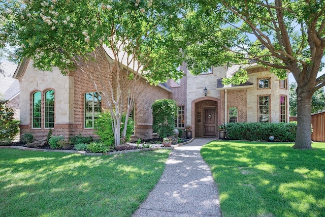 8116 Long Trail Dr, North Richland Hills, TX 76182 - view of front of house featuring stone siding, a front yard, and brick siding