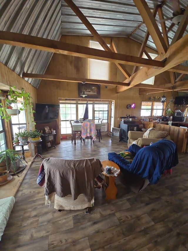 938 County Road 2509, Lometa, TX 76853 - living room with high vaulted ceiling, healthy amount of natural light, wood finished floors, and wood walls