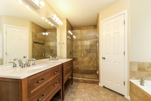 665 Cardinal Ridge Rd, Burleson, TX 76028 - full bath with double vanity, a stall shower, a bath, and a textured ceiling