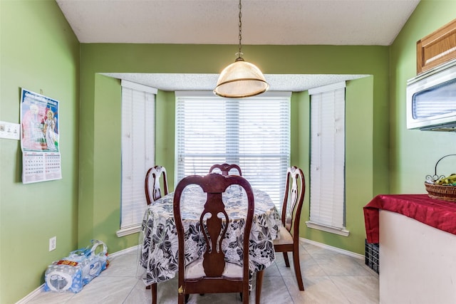 2123 Alto Ave, Carrollton, TX 75007 - dining room featuring plenty of natural light, baseboards, and light tile patterned floors
