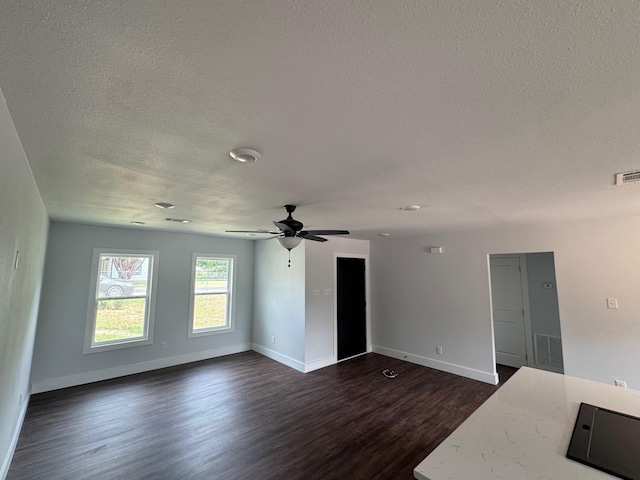120 Live Oak Dr, Sanctuary, TX 76020 - unfurnished living room with a textured ceiling, dark wood-style flooring, ceiling fan, and baseboards