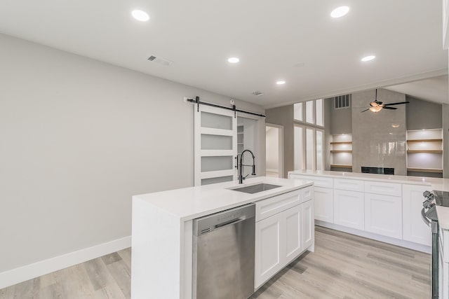 1103 Teakwood Dr, Duncanville, TX 75137 - kitchen with dishwasher, a barn door, a sink, an island with sink, and white cabinetry