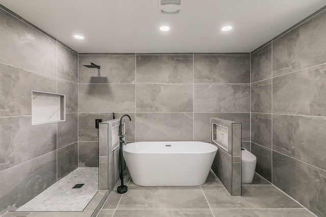1103 Teakwood Dr, Duncanville, TX 75137 - full bathroom featuring tile walls, a freestanding tub, toilet, tiled shower, and recessed lighting