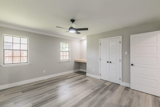 1103 Teakwood Dr, Duncanville, TX 75137 - unfurnished bedroom with wood finished floors, a closet, crown molding, baseboards, and a ceiling fan