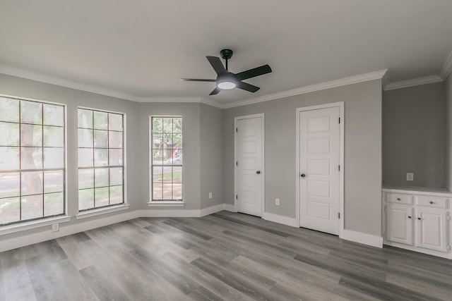 1103 Teakwood Dr, Duncanville, TX 75137 - unfurnished bedroom featuring dark wood-style floors, baseboards, crown molding, and a ceiling fan