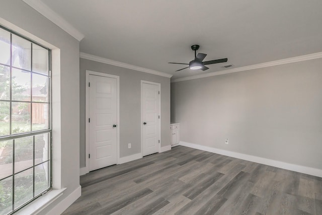 1103 Teakwood Dr, Duncanville, TX 75137 - unfurnished bedroom with multiple windows, ornamental molding, dark wood-type flooring, baseboards, and ceiling fan