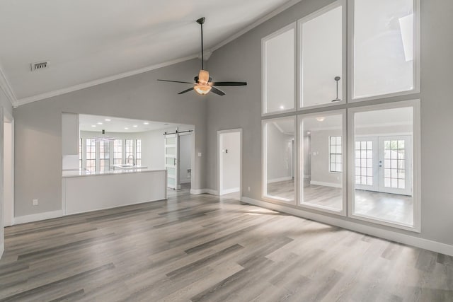 1103 Teakwood Dr, Duncanville, TX 75137 - unfurnished living room featuring a barn door, a ceiling fan, high vaulted ceiling, ornamental molding, and wood finished floors