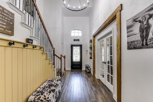 712 Saddleway Dr, Fort Worth, TX 76179 - foyer featuring wood finished floors, a towering ceiling, a chandelier, stairs, and french doors
