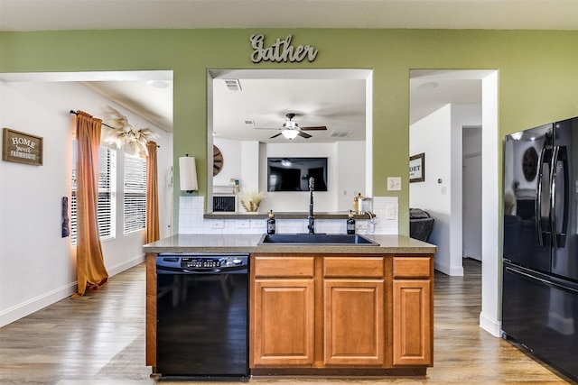 712 Saddleway Dr, Fort Worth, TX 76179 - kitchen with black appliances, light wood finished floors, a ceiling fan, and backsplash
