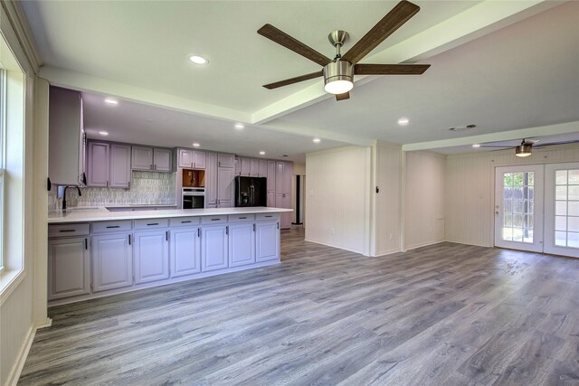 552 Oak Leaf Trl, East Tawakoni, TX 75472 - kitchen with oven, black fridge with ice dispenser, a ceiling fan, open floor plan, and recessed lighting