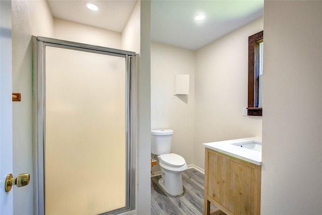 552 Oak Leaf Trl, East Tawakoni, TX 75472 - full bath featuring vanity, wood finished floors, a stall shower, toilet, and recessed lighting