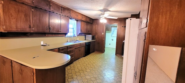 6121 Over Lake Dr, Fort Worth, TX 76135 - kitchen with stainless steel microwave, light floors, light countertops, black dishwasher, and a sink