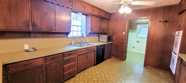 6121 Over Lake Dr, Fort Worth, TX 76135 - kitchen featuring dishwasher, a sink, stainless steel microwave, light countertops, and light floors