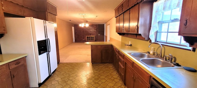 6121 Over Lake Dr, Fort Worth, TX 76135 - kitchen featuring white fridge with ice dispenser, light floors, a sink, and light countertops