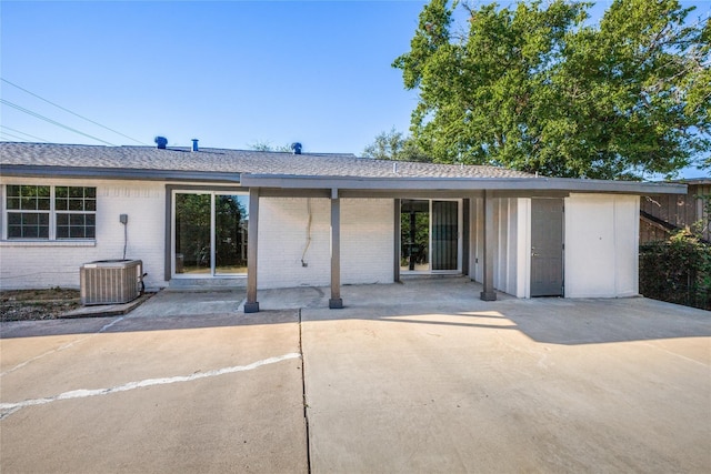 202 Kenway St, Rockwall, TX 75087 - view of front of home featuring brick siding, a patio, cooling unit, and a shingled roof