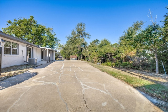 202 Kenway St, Rockwall, TX 75087 - view of patio featuring central air condition unit and driveway