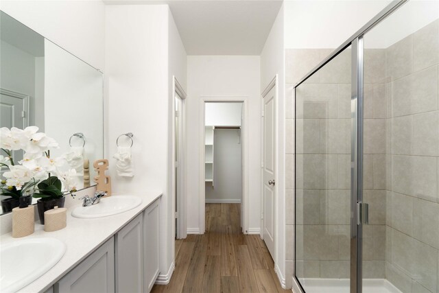 1236 Sequoia Ln, Princeton, TX 75407 - full bath with a shower stall, wood finished floors, double vanity, and baseboards
