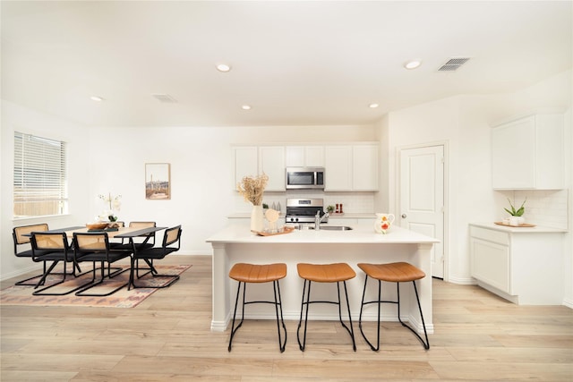 1236 Sequoia Ln, Princeton, TX 75407 - kitchen with appliances with stainless steel finishes, decorative backsplash, white cabinetry, and recessed lighting
