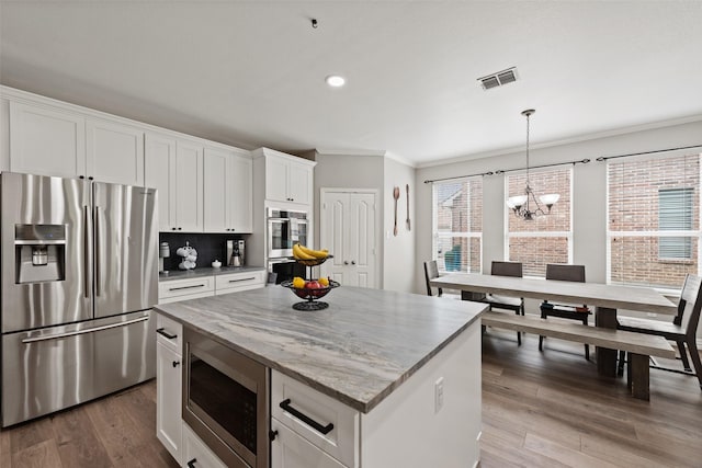 3516 Horace Ave, Fort Worth, TX 76244 - kitchen featuring appliances with stainless steel finishes, crown molding, a chandelier, a kitchen island, and recessed lighting
