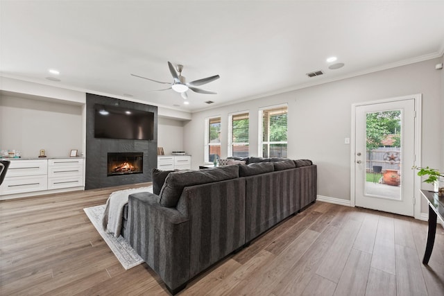 3516 Horace Ave, Fort Worth, TX 76244 - living room with ceiling fan, a premium fireplace, ornamental molding, light wood-style floors, and recessed lighting