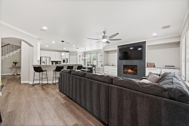 3516 Horace Ave, Fort Worth, TX 76244 - living room with a ceiling fan, crown molding, light wood-style flooring, a fireplace, and recessed lighting