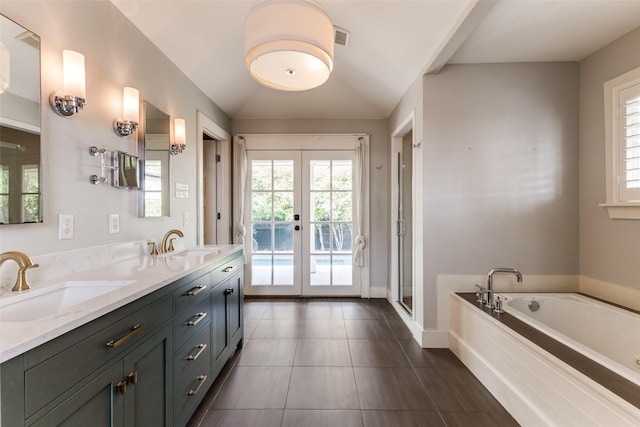 7107 La Vista Dr, Dallas, TX 75214 - bathroom featuring french doors, plenty of natural light, a garden tub, double vanity, and lofted ceiling