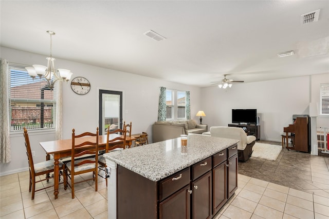 2841 Pacifico Way, Fort Worth, TX 76111 - kitchen featuring ceiling fan, a chandelier, dark brown cabinetry, decorative light fixtures, and light tile patterned floors