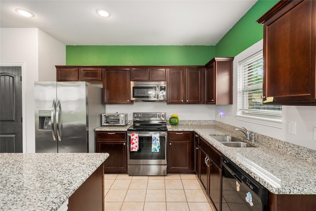2841 Pacifico Way, Fort Worth, TX 76111 - kitchen with stainless steel appliances, a sink, light tile patterned floors, light stone countertops, and recessed lighting