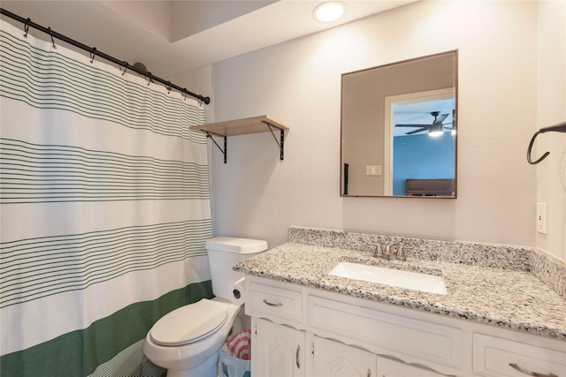 1654 Clarendon Dr, Lewisville, TX 75067 - bathroom with vanity, toilet, ceiling fan, a shower with shower curtain, and a textured wall
